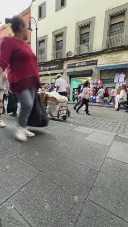 timelapse showcasing hustle and bustle of correo mayor street in mexico city. vertical shot