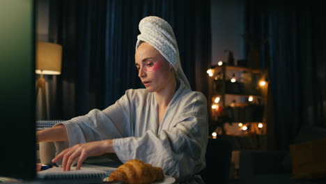 Serious-woman-rips-sheets-out-at-dark-place-closeup.-Bathrobe-lady-writing-notes