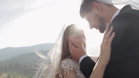 newlyweds. caucasian groom with bride on mountain slope. wedding couple. happy