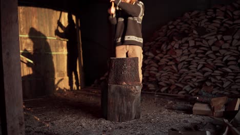 man with an ax chopping wood - wide shot