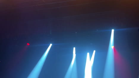 dynamic stage lighting with colorful beams illuminating a vibrant concert atmosphere