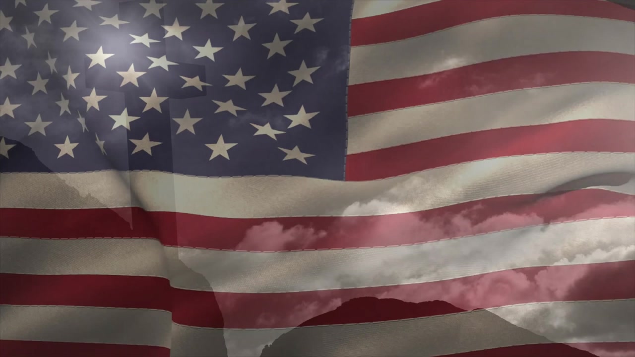 Light breeze picking up American flag and billowing smoothly while showcasing fluttering motion