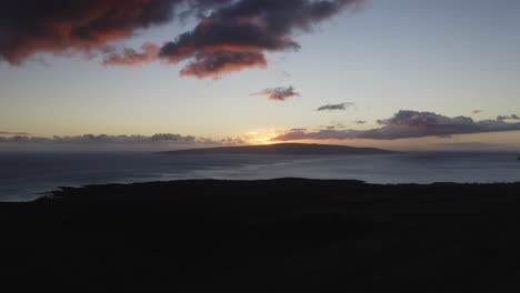 Clouds-illuminated-by-a-colorful-sunset-over-Kaho'olawe-island,-as-seen-from-Maui,-Hawai'i