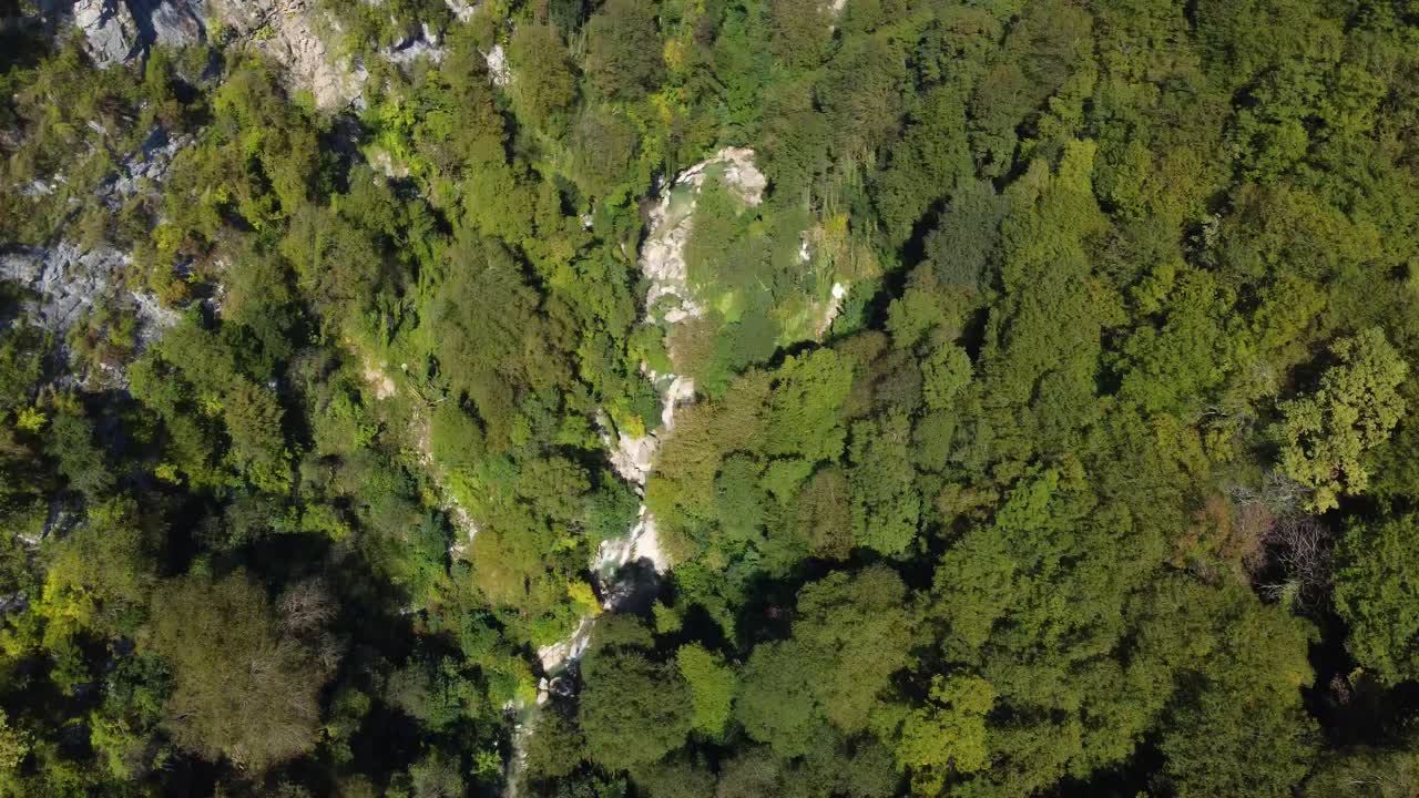 Tilted drone fly at Okatse Canyon mountain forest valley with hidden deep cliffs, Mtskheta-Mtianeti, Georgia