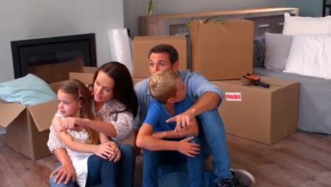 family relaxing while moving house