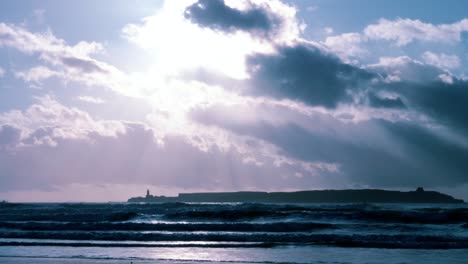 atmospheric serene empty beach scene with high waves and cloudy purple sky, in essaouira, morocco.