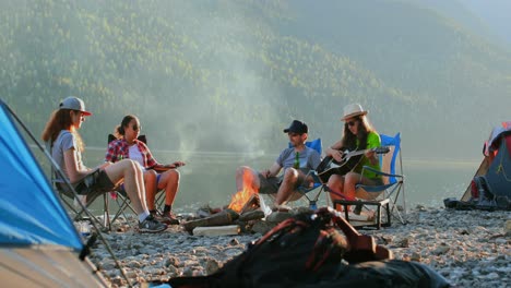 group of hikers camping near riverside 4k