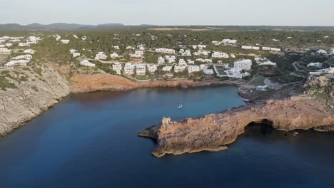 Drone-parallax-around-Cala-Morell-coastal-town-at-golden-hour