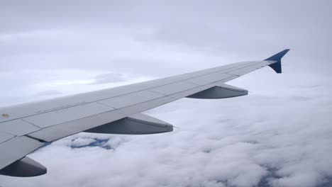 airplane wing producing lift in flight - passenger view