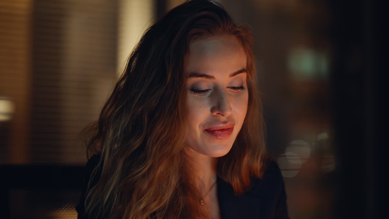 Smiling secretary working night reading emails portrait. Worker thinking ideas