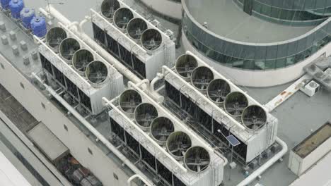 ventilation system on the building roof. rainy weather. industrial air system of ventilation and air conditioning. aerial shot.