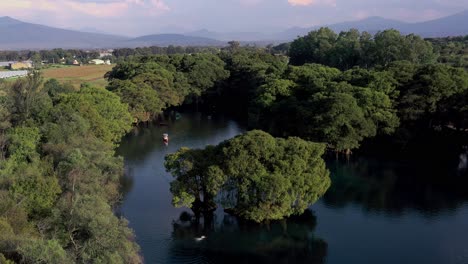 Aerial:-Lago-De-Camecuaro,-Boat,-Swimmer,-Tangancicuaro,-Mexico