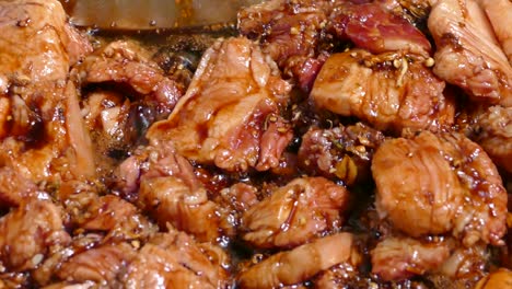 pork stew boiling in dark soy sause gravy, close up