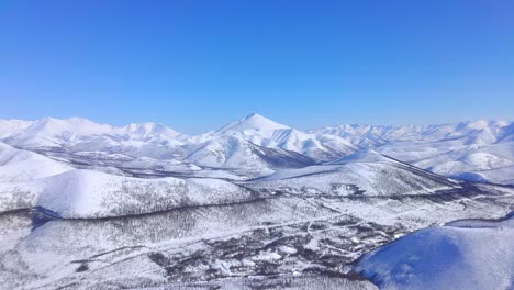 Bird's-eye-flight-over-snowy-mountains-drone-4k