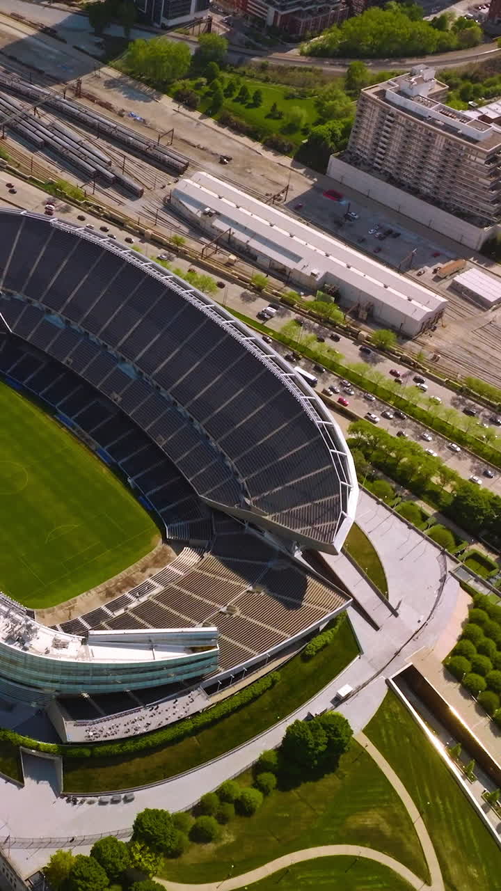 Stadium Soldier Field in Chicago. Aerial view on the structure in the green park at the backdrop of speed road. Vertical video