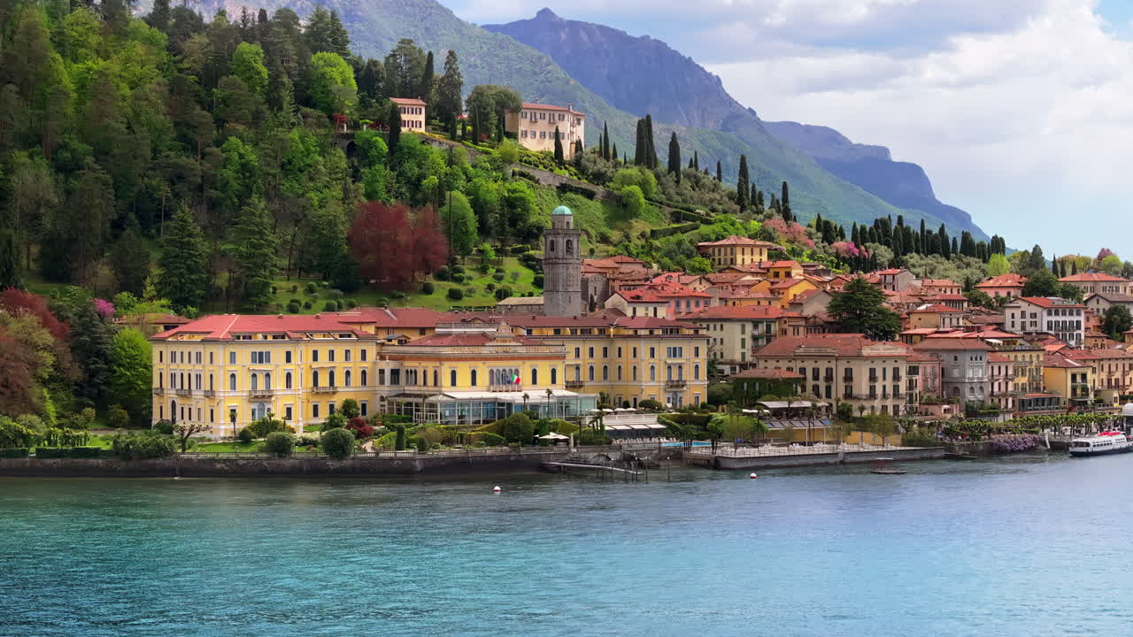 Aerial drone view of the Basilica of St. Giacomo surrounded by houses in Bellagio, Italy