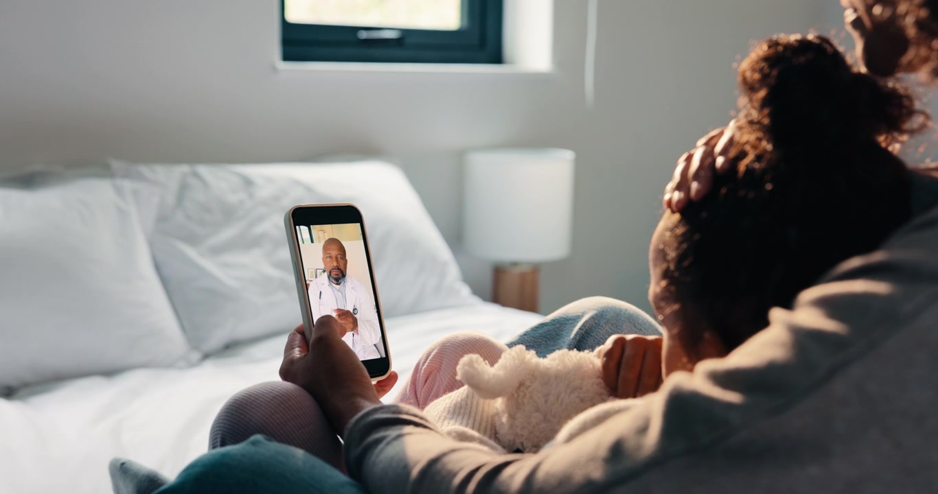 Mother and Child Having a Video Consultation with a Doctor