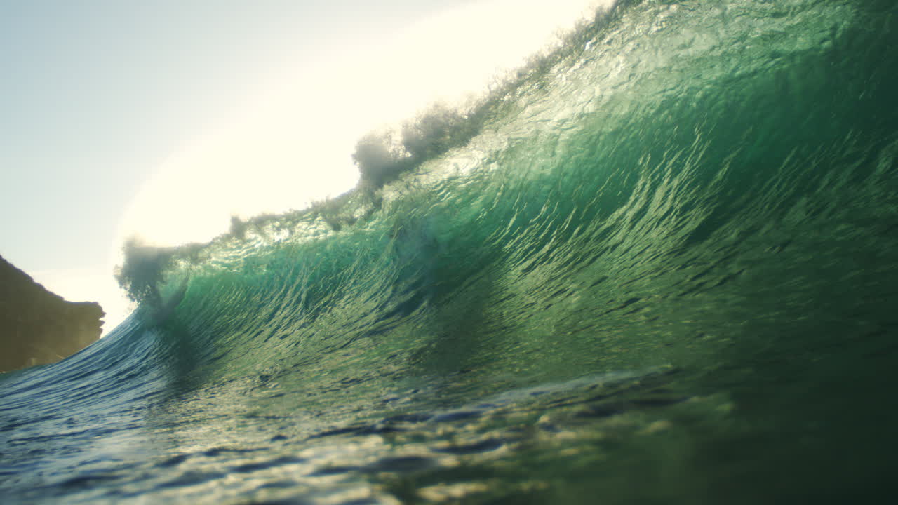 Sun flare and green wave textures collide in slow motion