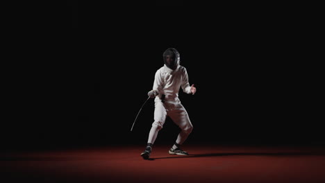 a fencer in a white uniform and mask stands on a red floor, holding a sword in a striking pose.