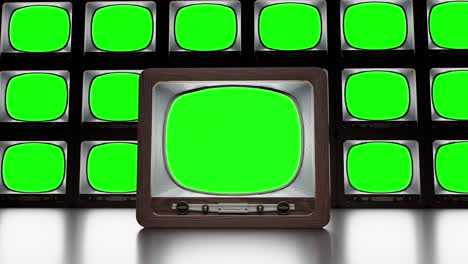 Set of retro TVs with green screen in dark studio