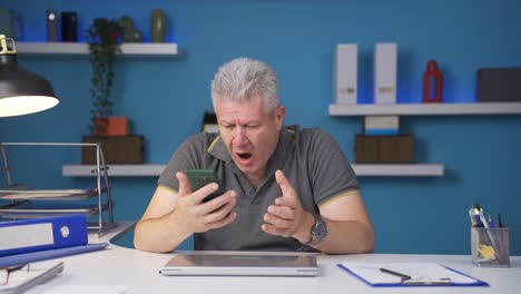 home office worker man getting bad news on the phone.