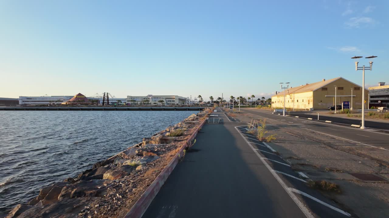 Long perspective of the Bay Trail at Alameda’s Seaplane Lagoon Ferry Terminal with open sky overhead
