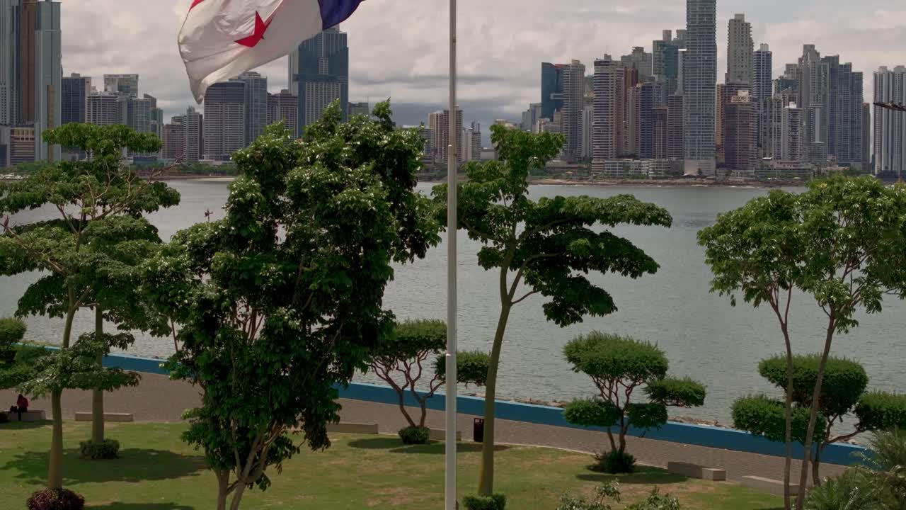 Ripresa aerea della bandiera di Panama con la città di Panama sullo sfondo.