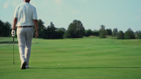 professional athlete playing golf outdoors. man walking golfing course in summer