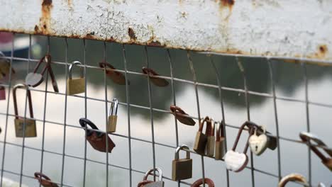 rusting love locks on a metal bridge