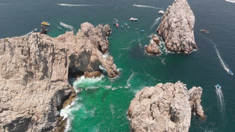 aerial view of rock formation and arch in ocean