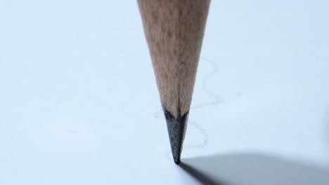 drawing lines on paper with pencil closeup