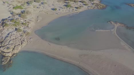 Aerial-view-of-a-walking-woman-on-a-idyllic-paradise-beach