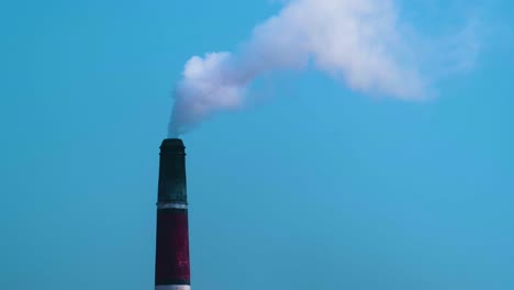 brick field chimney emitting harmful smoke into the air - environmental pollution concept