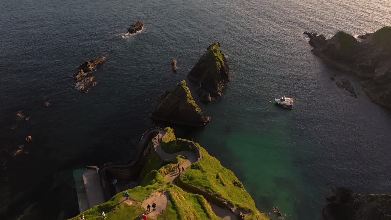 Golden sunset light over Dunquin Pier, with dramatic skies and sea views - Dingle Co.Kerry - 4K Cinematic Drone Footage 13.