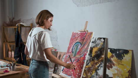 young woman painting a canvas