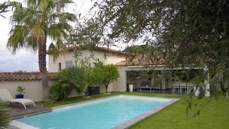 establishing shot of a luxury villa in france with a beautiful swimming pool