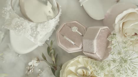 tight shot of wedding rings bands displayed next to the brides bouquet