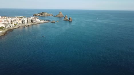 drone flight along the coastline near the cyclopean islands, sicily, italy