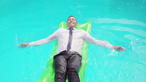 businessman lying on lilo