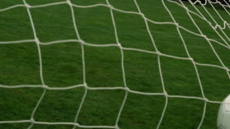 football hitting the back of the net
