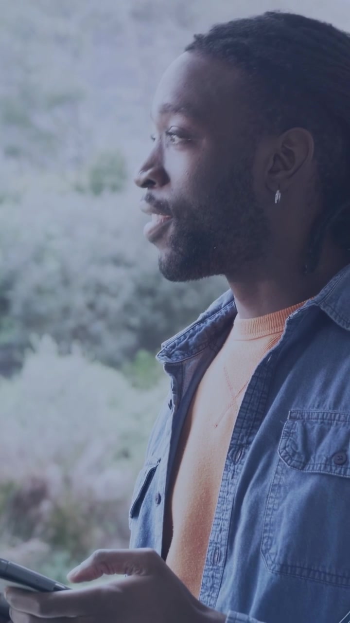Vertical video: Adult man tapping phone and checking messages, activating animated lines for UI