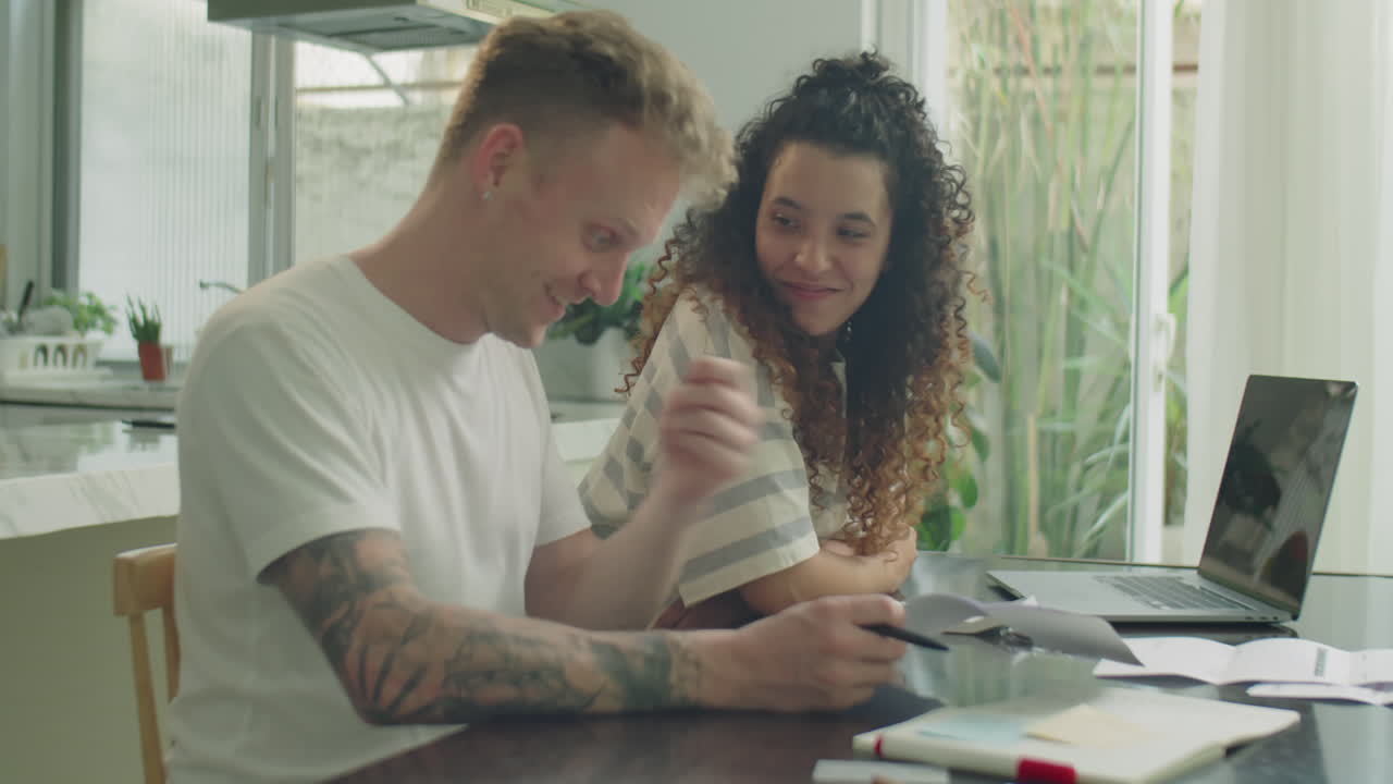 Young Couple Discussing Family Budget at Home