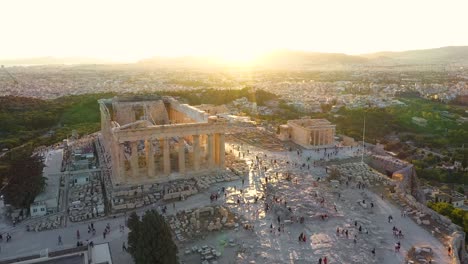 Cinematic-shot-of-the-flag-of-Greece,-Acropolis-city-of-Athens-parthenon,-Mount-Lycabettus,-Parliament-Building-and-residential-buildings,-sunrise-summer-in-Athens,-Greece