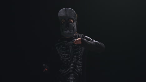 Studio-Shot-Of-Child-Dressed-Up-In-Skeleton-Costume-Trick-Or-Treating-At-Halloween-Dancing-Against-Black-Background-8