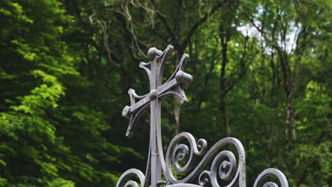 cast iron cross on ornate gate arch of mtsvane monastery, georgia