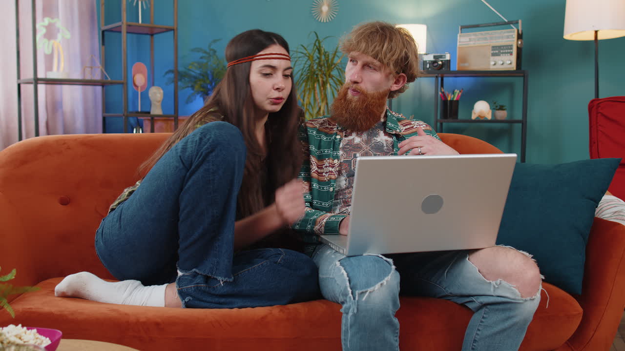 Family couple man woman works on laptop sends messages makes online purchases watching movies