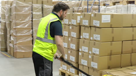 pallet truck forklift worker inside a factory warehouse moving package ready for shipping