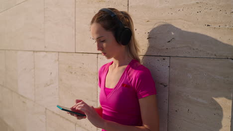 woman using phone while listening to music outside