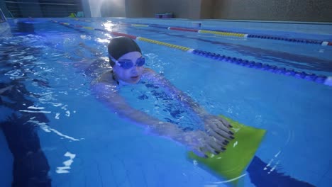 sporty young woman swimming in pool