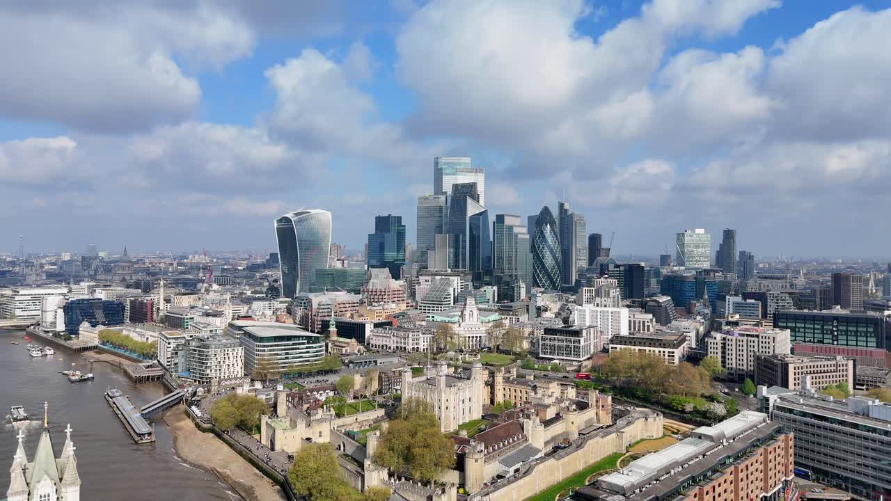 Stunning drone footage captures an aerial approach to the City of London, with beautiful clouds in the background and a gleaming skyline of modern skyscrapers rising above historic architecture.